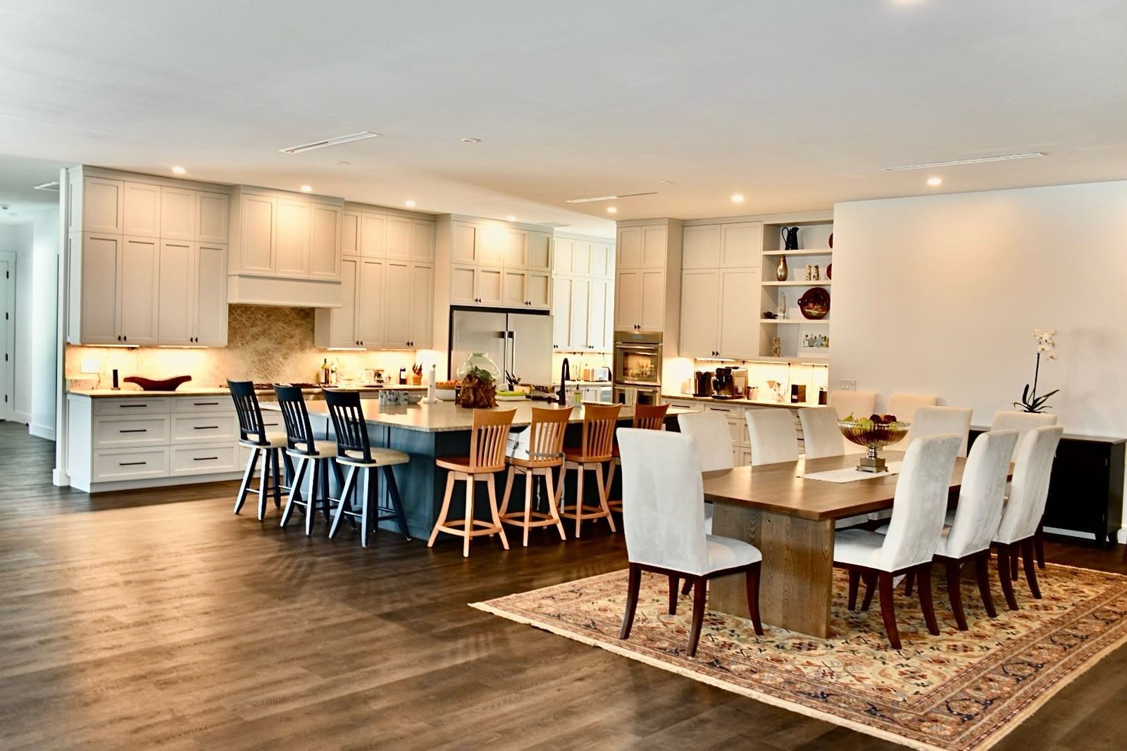 Open-plan kitchen and dining room with custom cabinetry and a professionally finished island